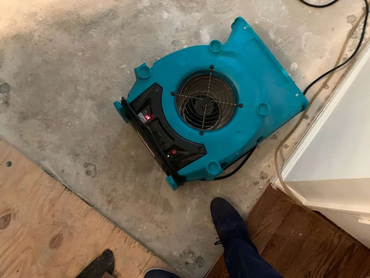 Air mover drying subfloor during Commercial Water Damage Restoration in Du Quoin